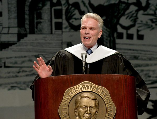 Brad D. Smith standing at a podium and speaking at a Marshall University graduation ceremony.