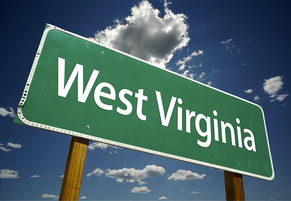 Green road sign that reads "West Virginia"