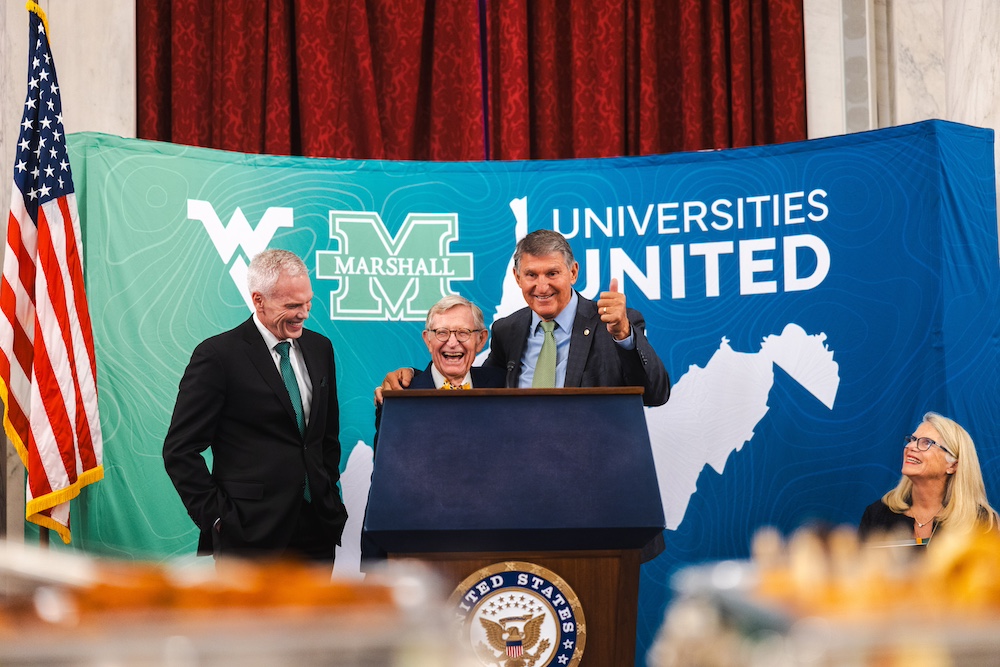 Brad D. Smith stands smiling next to a laughing Gordon Gee, West Virginia University’s president, at the Universities United event in Washington, DC.