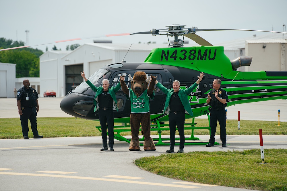 Brad D. Smith stands in front of the Marshall University Helicopter at the Helicopter Event on campus.