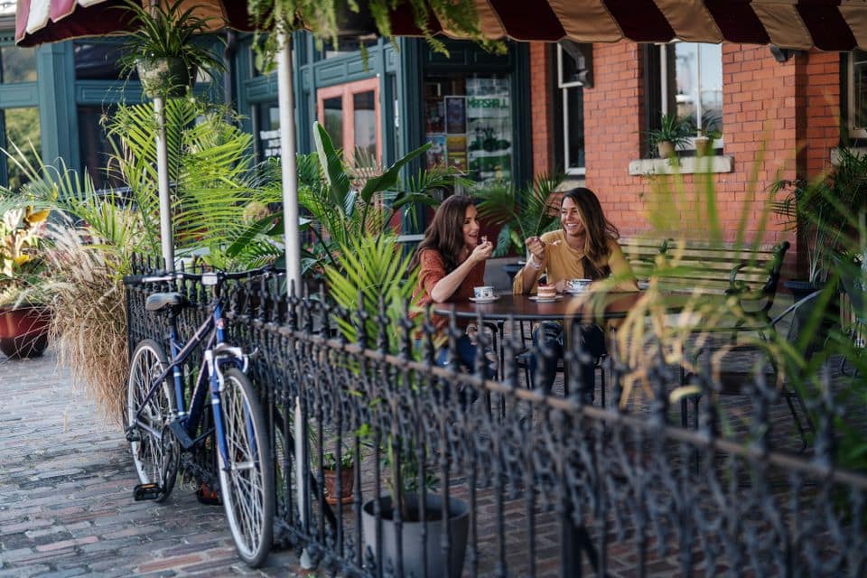 First Ascent members share a meal together on the patio of a restaurant in Huntington, West Virginia.