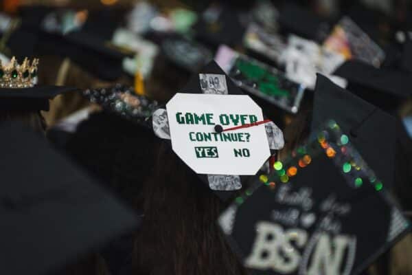 A Marshall University cap with the words “Game Over, Continue? Yes or No” written on the top. The “Yes” response is circled.