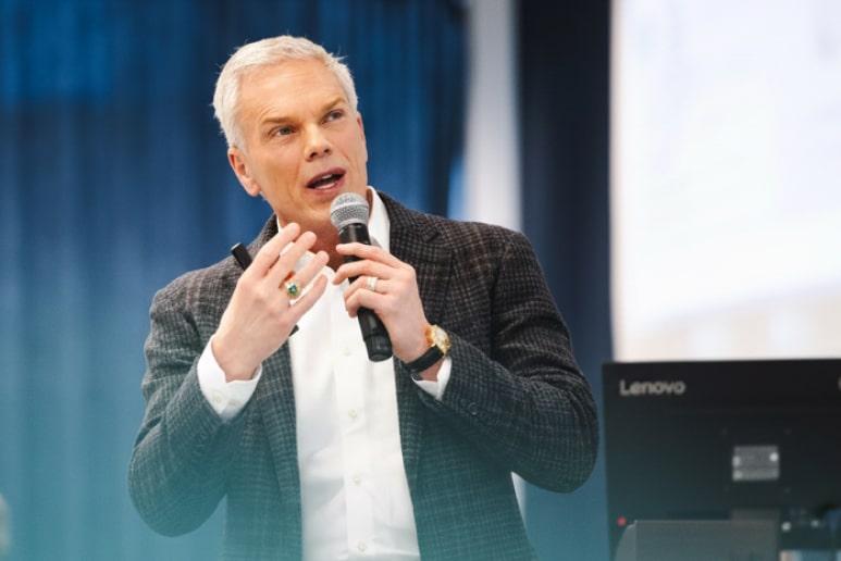 Brad D. Smith speaking into a microphone