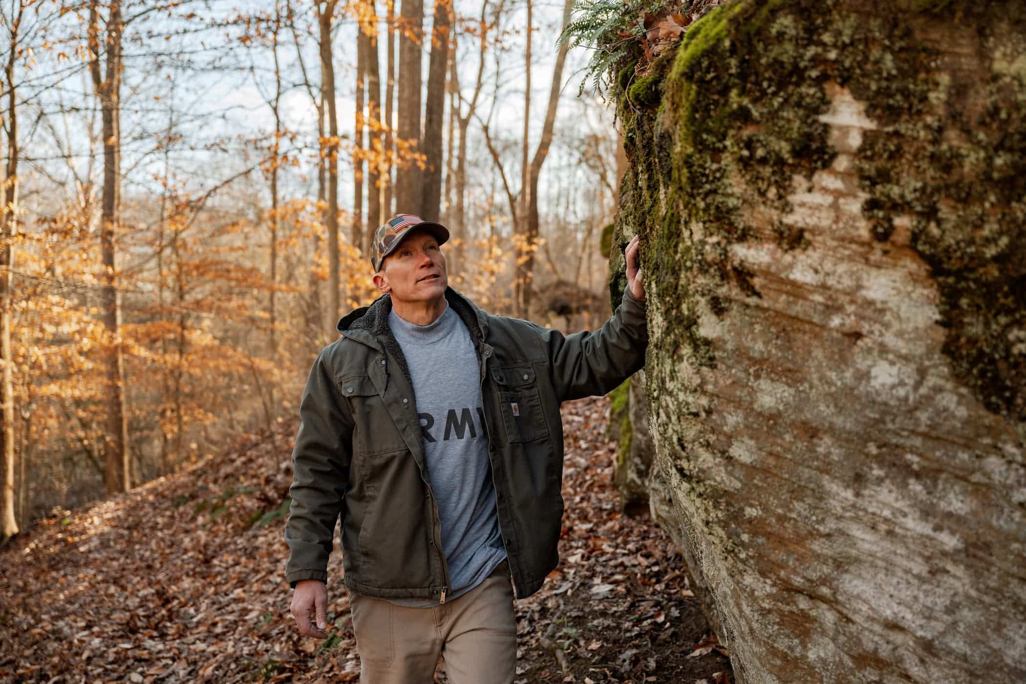 U.S. Army veteran hiking in the mountains of West Virginia in a camo hat and army t-shirt